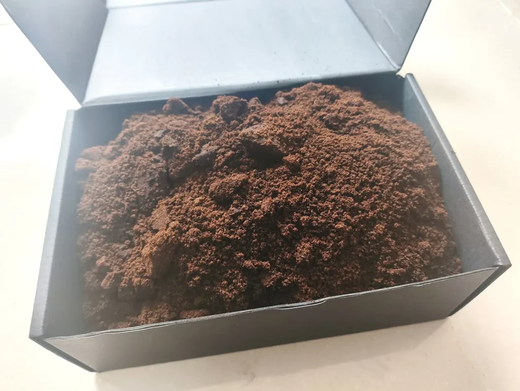 Bags of used coffee grounds given away by a coffee shop for gardeners