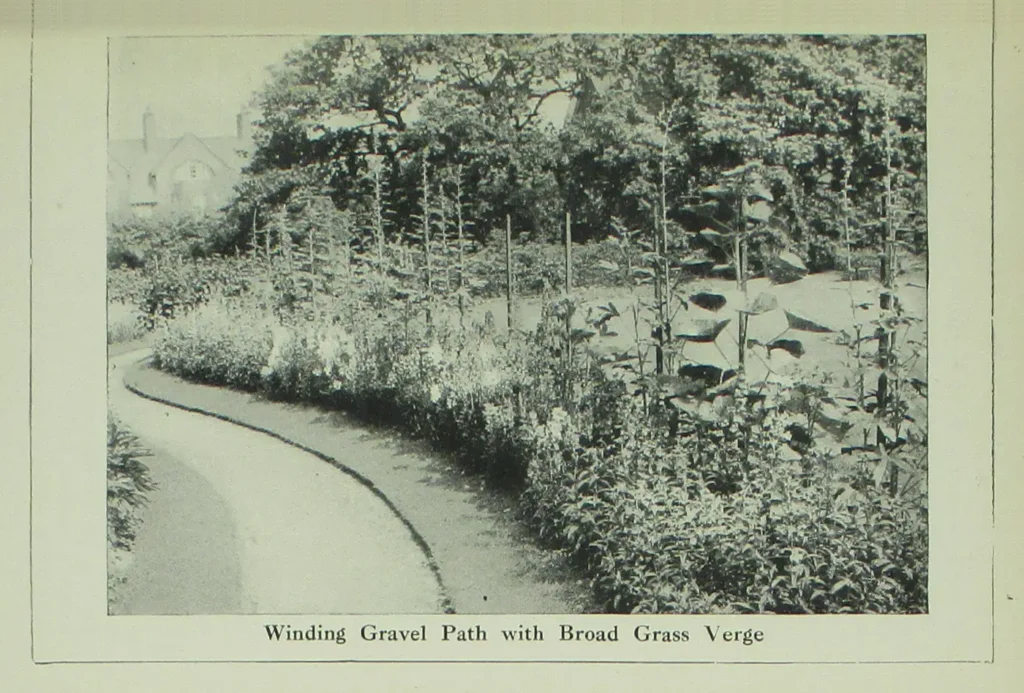 A winding gravel garden path with grass edges
